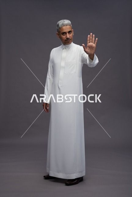 Saudi Man in Traditional Thobe Making Stop Gesture