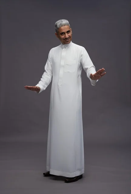 Saudi Man in White Thobe Gesturing on Grey Background
