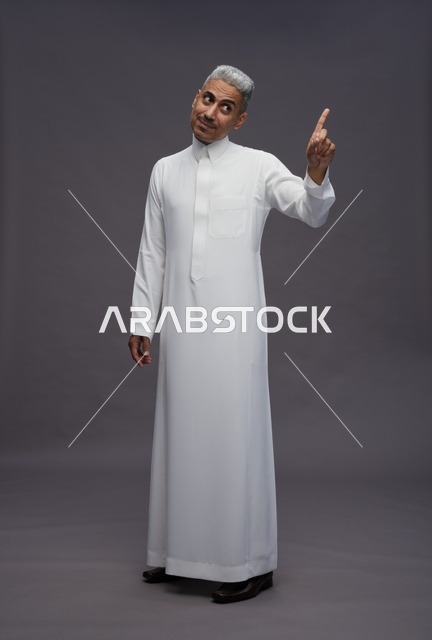Saudi Man in Traditional Thobe Pointing Upward