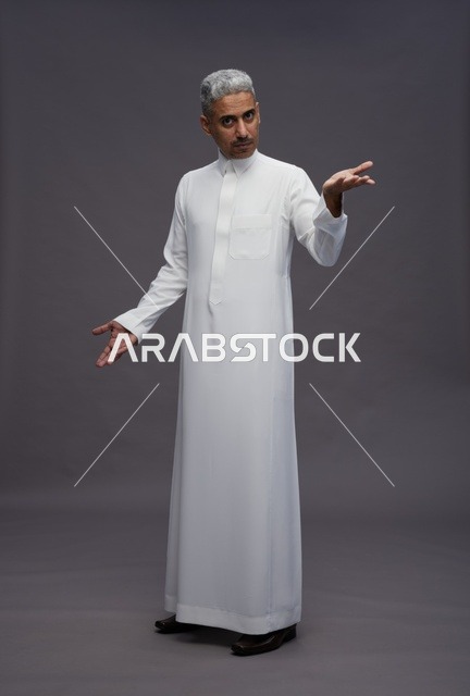 Saudi Man in Traditional White Thobe Gesturing