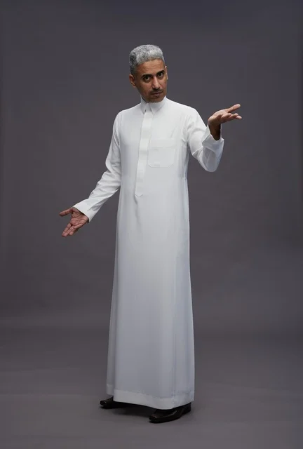 Saudi Man in Traditional White Thobe Gesturing