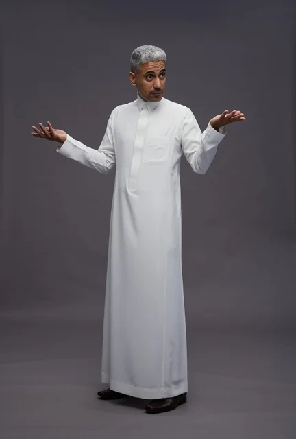 Saudi Man in White Thobe Shrugging on Gray Background