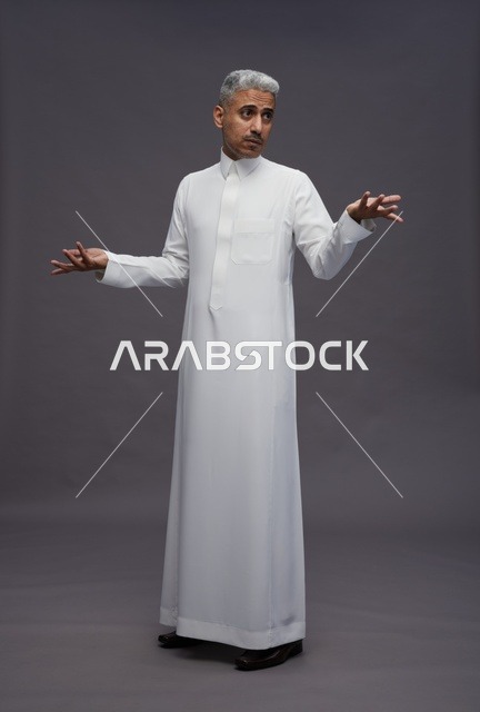 Saudi Man in White Thobe Gesturing on Gray Background