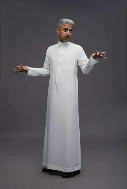 Saudi Man in White Thobe Gesturing on Gray Background