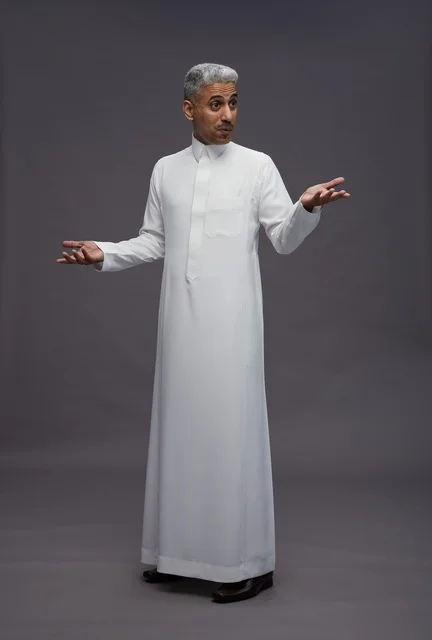 Saudi Man in White Thobe Gesturing on Grey Background