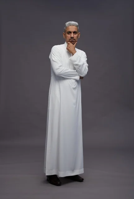 Thinking Saudi Man in White Thobe on Grey Background