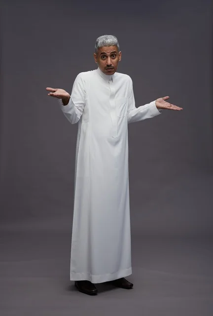 Saudi Man in White Thobe Shrugging on Grey Background