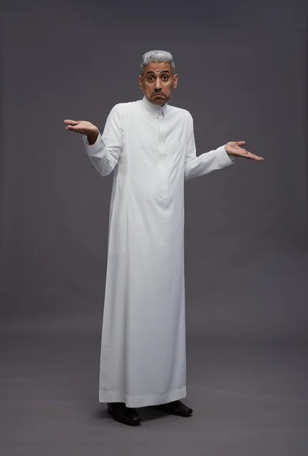 Saudi Man in White Thobe Shrugging on Grey Background