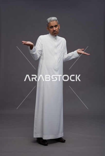 Saudi Man in White Thobe Shrugging on Grey Background