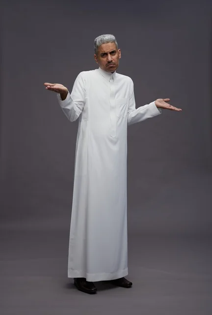 Saudi Man in White Thobe Shrugging on Grey Background