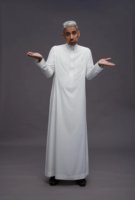 Saudi Man Shrugging in White Thobe on Grey Background