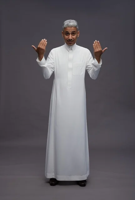 Saudi Man in White Thobe Gesturing on Grey Background