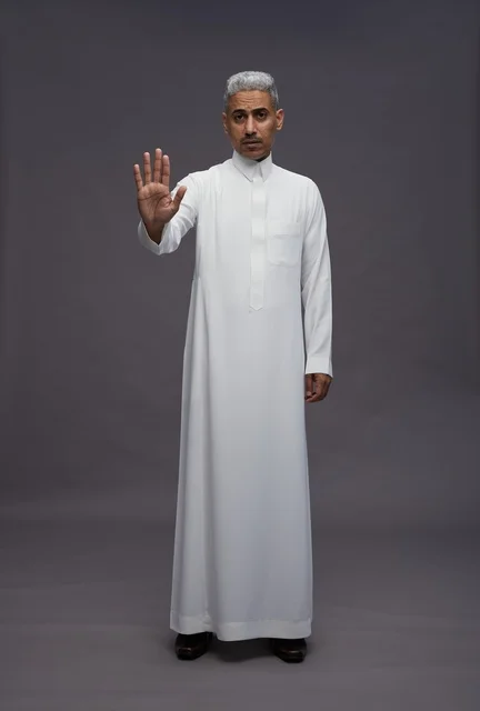Saudi Man in White Thobe Making Stop Gesture