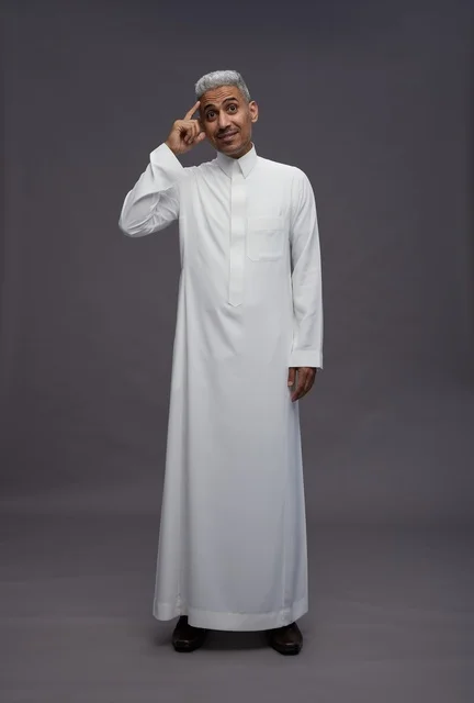 Thinking Saudi Man in Traditional Thobe on Grey Background