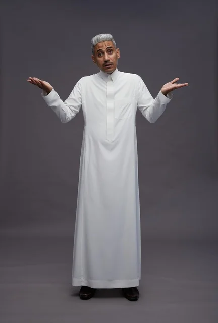 Saudi Man in White Thobe Shrugging on Grey Background