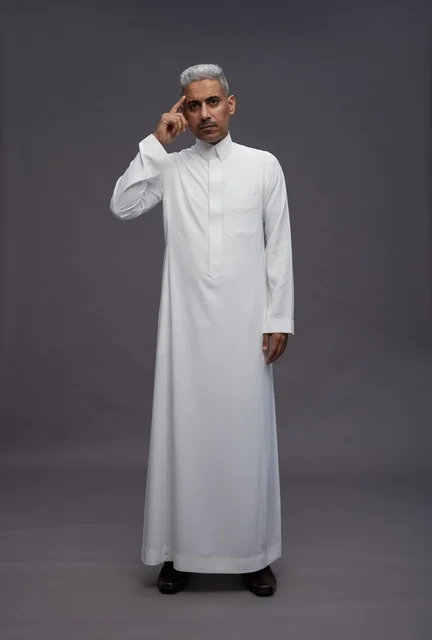 Saudi Man in White Thobe Thinking on Gray Background