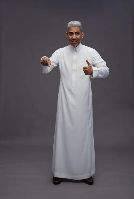 Saudi Man in White Thobe Giving Thumbs Up