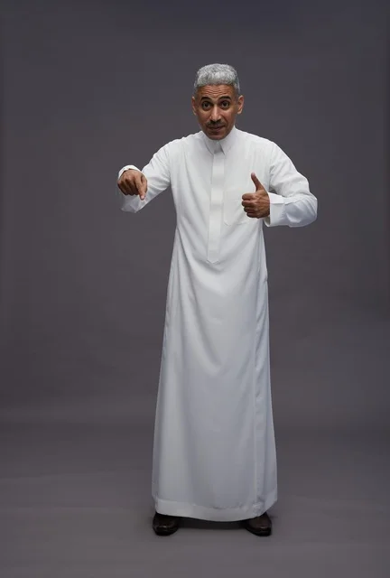 Saudi Man in White Thobe Pointing Down and Thumbs Up