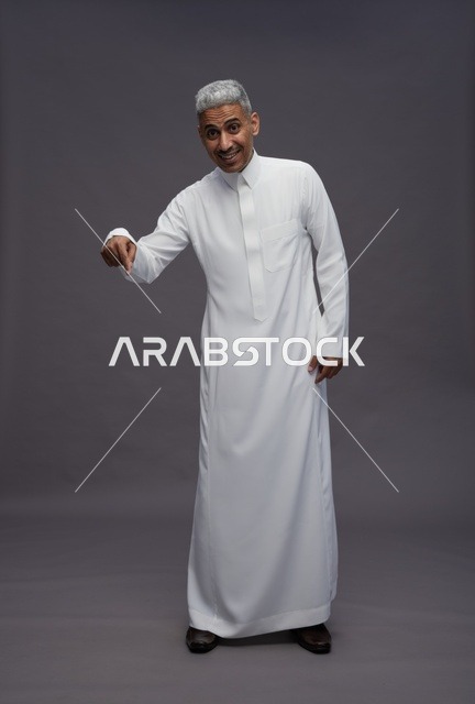 Saudi Man in White Thobe Pointing Down Grey Background