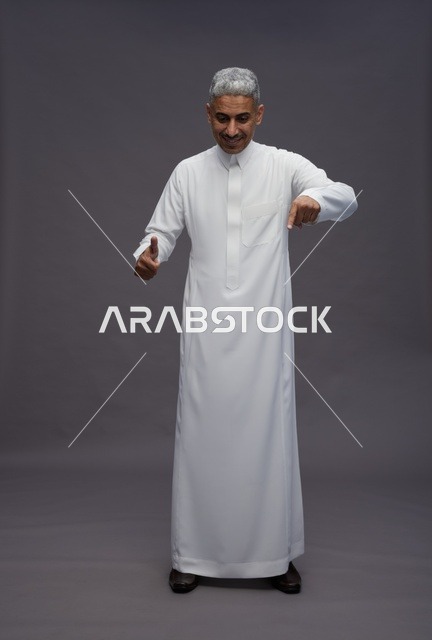Saudi Man in Traditional Thobe Pointing Downwards