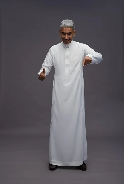 Saudi Man in Traditional Thobe Pointing Downwards