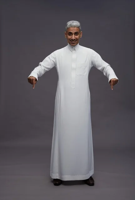 Saudi Man in Thobe Pointing Down on Grey Background