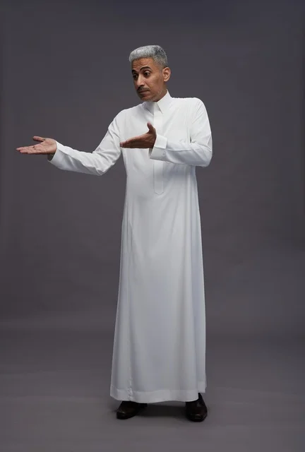 Saudi Man in White Thobe Gesturing on Grey Background