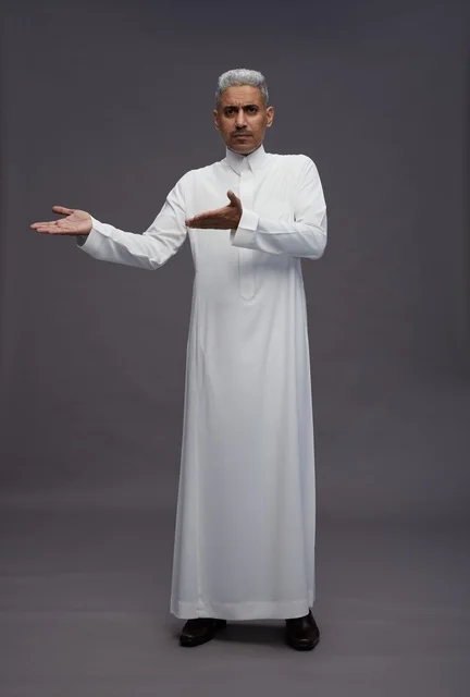 Saudi Man in White Thobe Gesturing on Grey Background