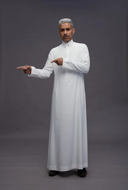 Saudi Man in White Thobe Pointing on Grey Background