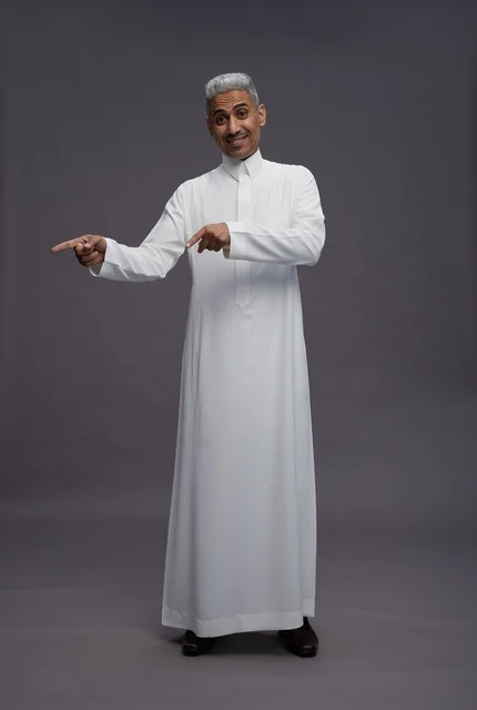Saudi Man in Thobe Pointing at Grey Background