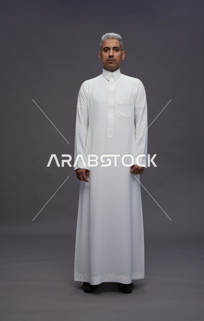 Saudi Man in Traditional White Thobe on Grey Background