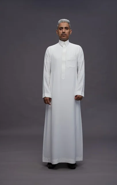 Saudi Man in Traditional White Thobe on Grey Background
