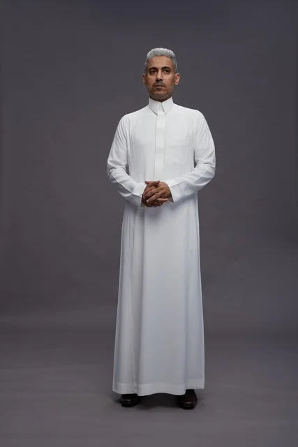 Saudi Man in Traditional White Thobe on Grey Background