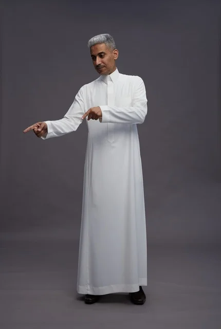 Saudi Man in White Thobe Pointing on Grey Background