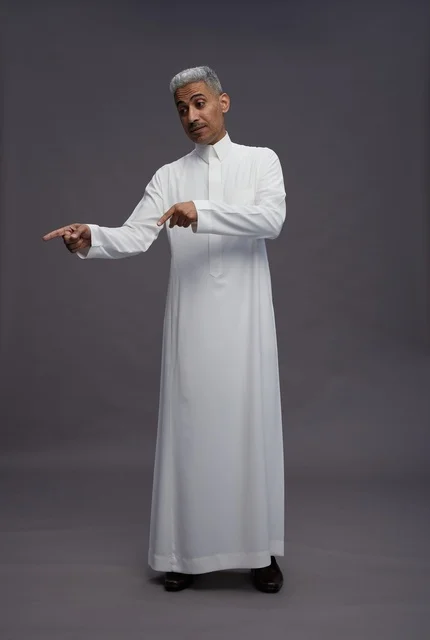 Saudi Man in White Thobe Pointing on Grey Background