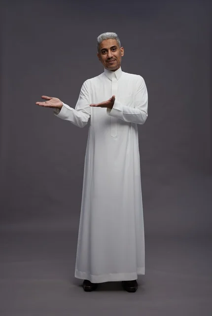 Saudi Man in White Thobe Pointing on Grey Background