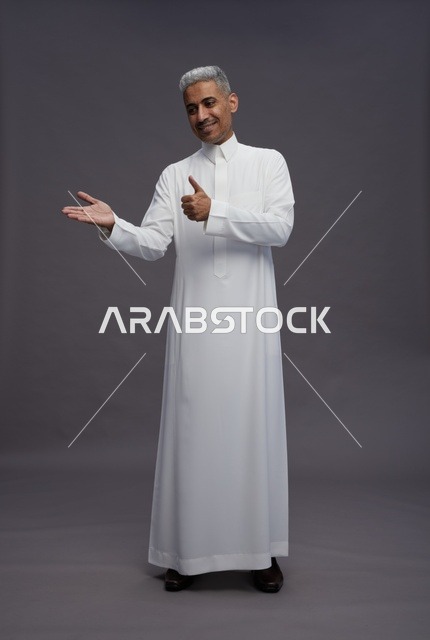 Saudi Man in White Thobe Giving Thumbs Up Gesture