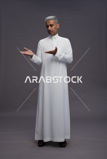 Saudi Man in White Thobe Gesturing on Grey Background