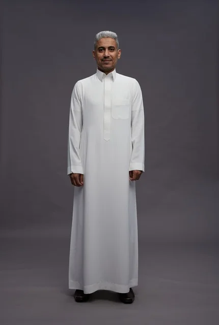 Saudi man in white thobe engaging with the camera