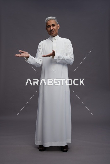 Saudi man in white thobe engaging with the camera