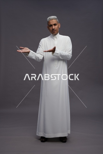 Saudi man in white thobe engaging with the camera
