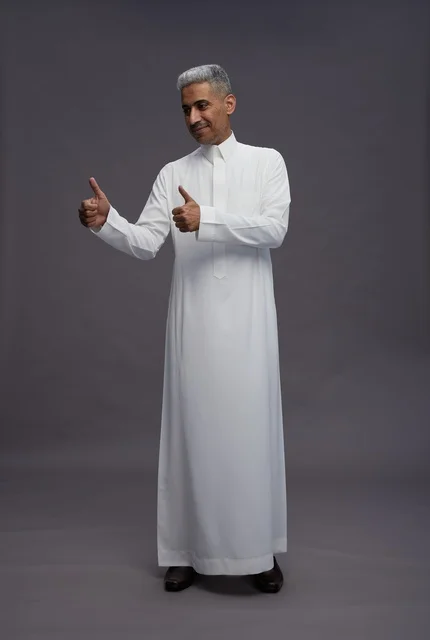 Saudi man in white thobe engaging with the camera