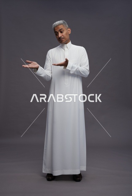 Saudi man in white thobe engaging with the camera