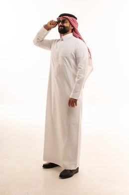 رجل سعودي بالثوب التقليدي يعدل نظارته الشمسية