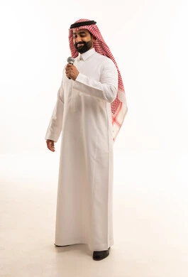 Saudi Man in Traditional Thobe Holding Microphone