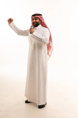 Saudi Man in Traditional Thobe Speaking with Microphone