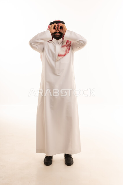 رجل سعودي بالثوب التقليدي يحاكي حركة المنظار