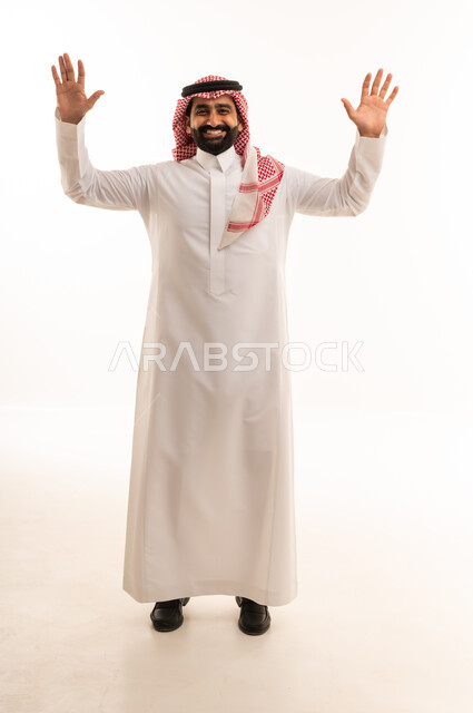 Smiling Saudi Man in Traditional Thobe with Raised Hands