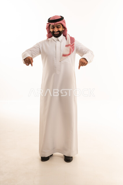 Saudi Man in Traditional Dress Pointing Downward
