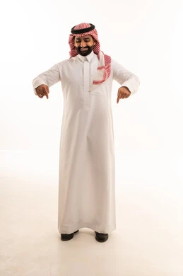 Saudi Man in Traditional Dress Pointing Downward